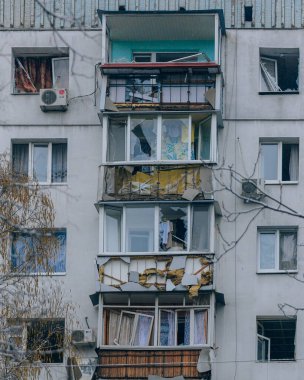 Ukrayna 'da bir konut binasının bombalanmasının sonuçları. Duvarlarda, çatıda ve pencerelerde hasar var. Bir konut binasının yıkımı. Bir yerleşim alanının bombalanması, siviller.