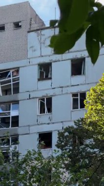 A damaged residential building with burnt-out balconies after shelling or fire. Broken windows and collapsed balcony structures are visible, the consequences of a conflict of damage.