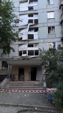 A plan of the faade of an apartment building with severe war damage. Broken and twisted window frames are visible, highlighting the damage to civilian infrastructure.