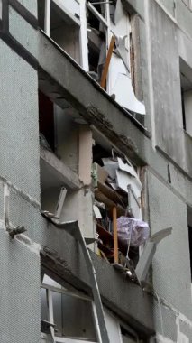 A plan of the faade of an apartment building with severe war damage. Broken and twisted window frames are visible, highlighting the damage to civilian infrastructure.