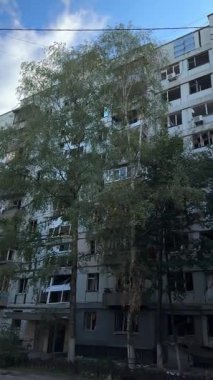 A plan of the faade of an apartment building with severe war damage. Broken and twisted window frames are visible, highlighting the damage to civilian infrastructure.
