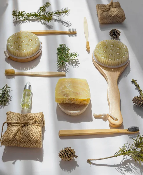 Set of Eco cosmetics products and tools. Handmade soap, serum bottle, bamboo toothbrush, natural wooden brush on white background with shadow. Plastic free, zero waste, sustainable lifestyle concept.