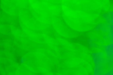 Soyut yeşil bokeh arkaplanı. Odaklanamayan ışıklar. Parti, tatil ve festival konsepti