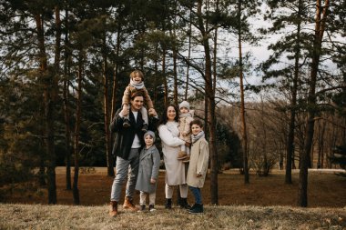 Big family with four children outdoors. Family spending time together on an autumn day. clipart