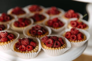 Raspberry cupcakes on a candy bar, closeup.