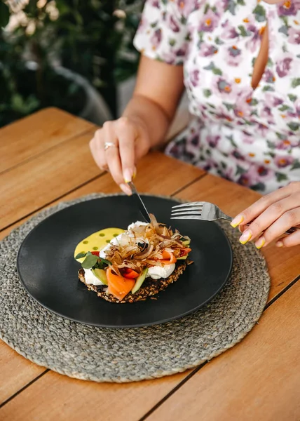 Person Having Breakfast Poached Egg Toast Salmon Avocado Garnished Herbs — Stock Photo, Image