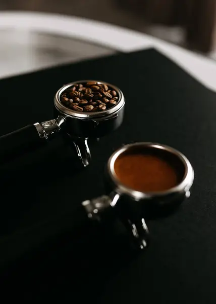 Two Espresso Portafilters Black Surface One Filled Coffee Beans Other Royalty Free Stock Photos