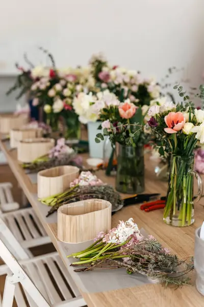 stock image Floral arrangement workspace with fresh cut flowers.