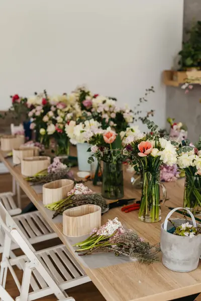 stock image Floral arrangement workspace with fresh cut flowers.