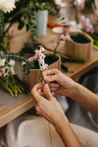 Close Hands Gently Preparing Pink Hyacinth Stem Floral Arrangement Wooden Royalty Free Stock Photos