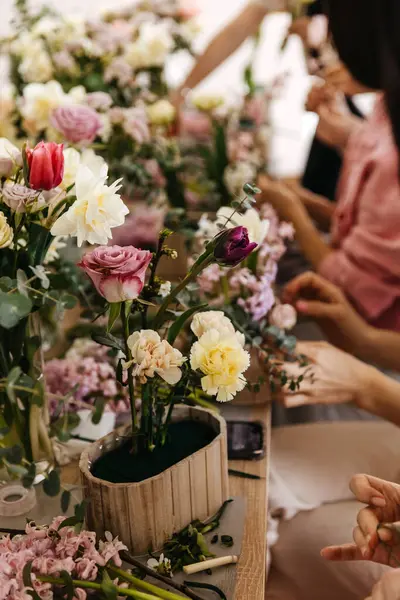 Busy Floral Arrangement Session Hands Carefully Placing Variety Flowers Wooden Stock Picture