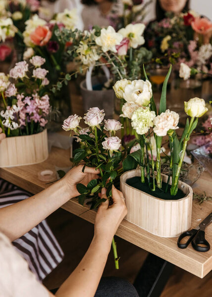 Close Floral Arrangement Class Hands Placing Pale Roses Wooden Pot Stock Image