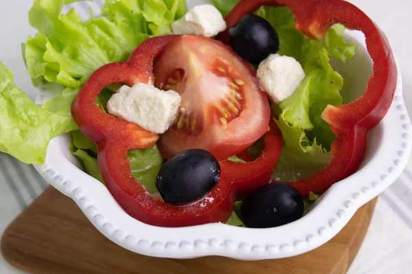 Traditional Greek Food, Vegetable Salad, Lettuce, Tomatoes, Bell Pepper and Feta Cheese , Topped with Olives