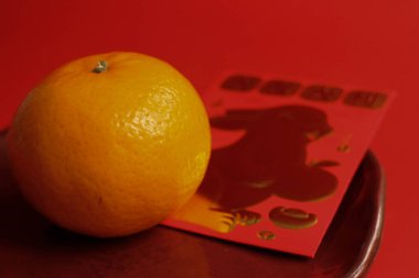 Orange and the Lucky Red Envelope with the Script in Chinese, Good Luck and Rabbit in Gold printed