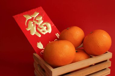 Oranges in a basket with the Lucky Red Envelope with the Script 