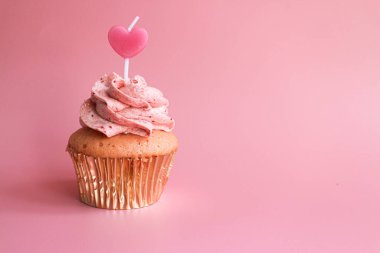 Strawberry Cup cake topped with a Pink Candle to Celebrate Valentine's Day , Pastel Pink Background