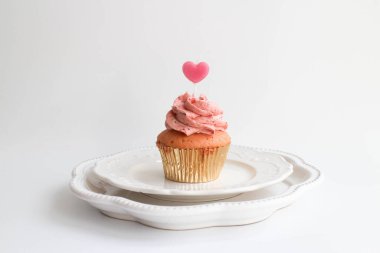 Strawberry Cup cake topped with a Pink Candle to Celebrate Valentine's Day , White Background