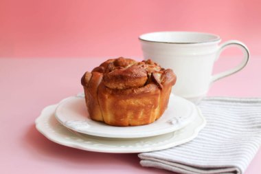 Delicious bread with a cup of coffee on Pink Background