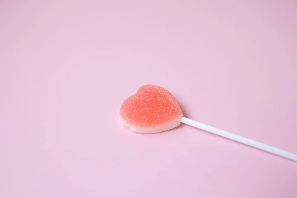 Pink Jelly coated with icing on Pink Background for Valentine's day