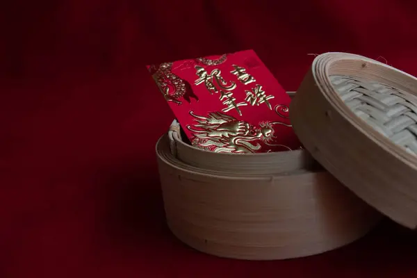 Red Lucky Envelope with Chinese Script for Good Luck in Dim-Sum basket