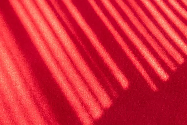 Shadow of the stripe on the red fabric