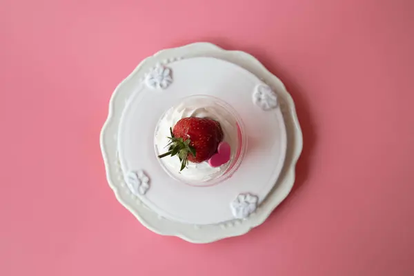 Strawberry jelly topped with white whip cream and Fresh Strawberry with Pink Heart, Pink Background