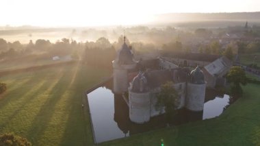 Güneş doğarken Chateau de Lavaux-Sainte-Anne 'in büyüleyici siluetini hissedin. Şatoyu çevreleyen sakin sulara ve huzurlu manzaraya altın bir parıltı saçın..
