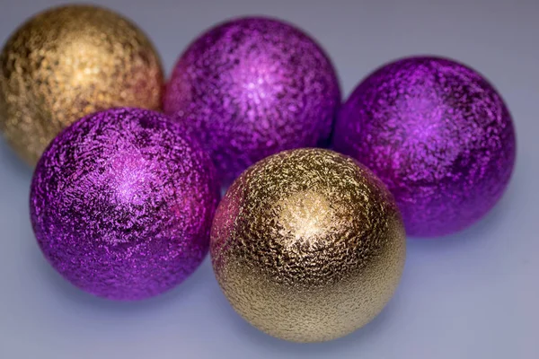 Christmas gold and purple Christmas balls for a Christmas tree close-up. Place for your text.