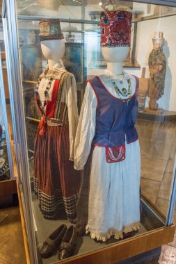 KURESSAARE, ESTONIA - 11 July, 2024: museum exhibits. Estonian national clothes in hall of Kuressaare Castle, Saaremaa. clipart