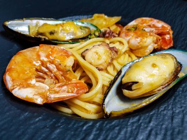 italian seafood pulpo and shells with pasta