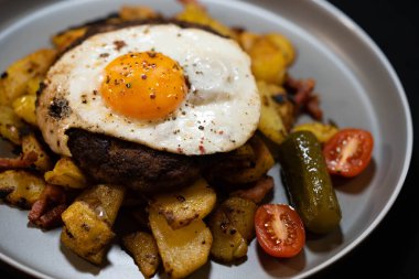 Hacksteak a la Meier Beefsteak with  fried eggs and roasted potatoes