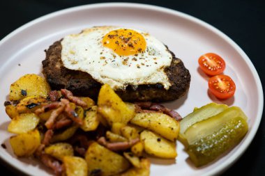 Hacksteak a la Meier Beefsteak with  fried eggs and roasted potatoes