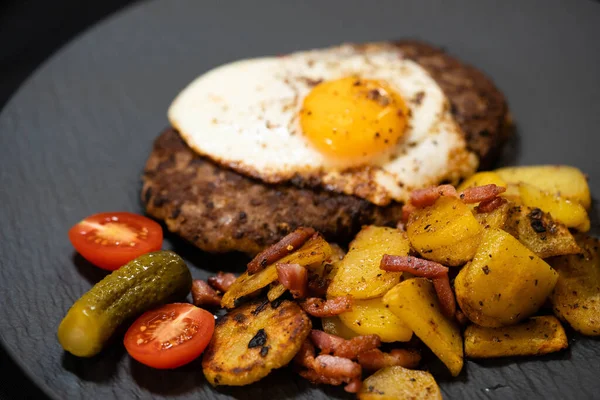 Hacksteak a la Meier Beefsteak with  fried eggs and roasted potatoes