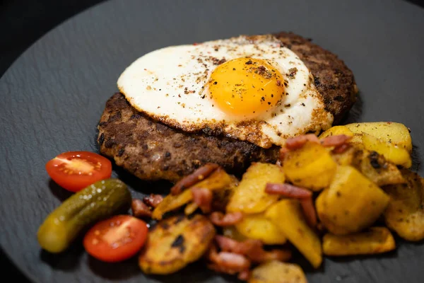 Hacksteak a la Meier Beefsteak with  fried eggs and roasted potatoes