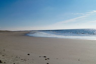 the endless beach at the northern sea Hvidbjerg Stranden Blavand Denmark clipart