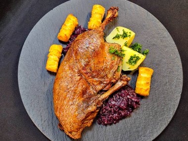 Kızarmış ördek, kırmızı lahana ve patates.