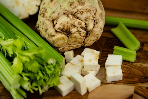 stock image Fresh celery Apium graveolens on olive wood