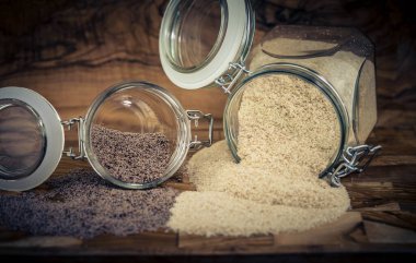 Psyllium seeds and psyllium husks on olive wood clipart