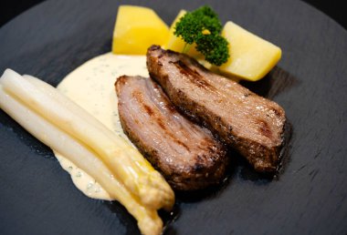 Tafelspitz of veal with asparagus and parsley sauce clipart