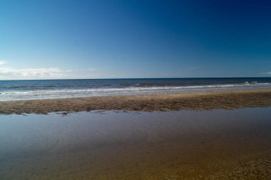 Impressions of the endless beach at the northern sea in Blavand Denmark clipart