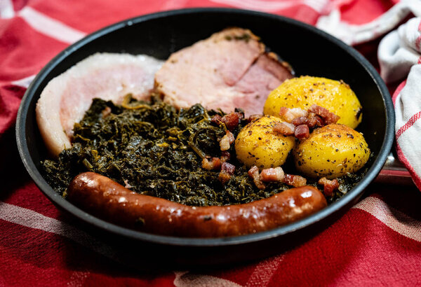 North German national dish green cabbage with roast pork, cabbage sausage and roast potatoes