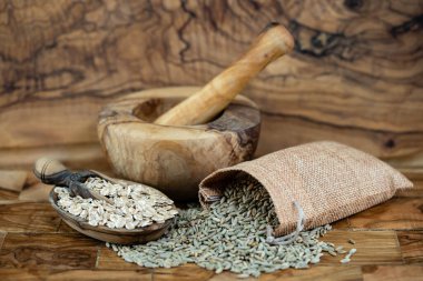 whole grain Secale cereale rye flakes on olive wood