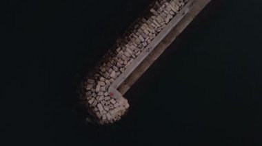 Kayalar ve kristal berrak zümrüt suyu ile sakin deniz dalgalarının en üst düzey drone görüntüsü, Toskana 'da Porto Ercole kasabası manzarası, İtalya günbatımı