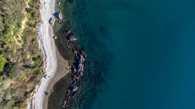 Fantastic landscape taken from the drone at the top of the cliff. Trieste, Italy. Clear sea and blue sky. Rocks and sand.
