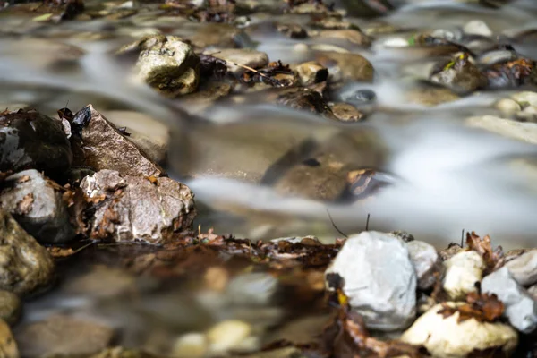 Long exposure of water on river stones