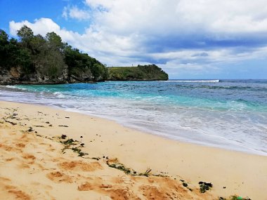 Dream Land Beach, at Uluwatu area, with beautiful rock formation, during nice weather clipart