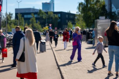 Blurred Shot Of People On Warm Autumn Day In City On Streets Of Riga, Latvia. High quality photo