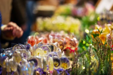 In Frame Of Caramel On Stick With Pattern Of Yellow - Purple Flowers. Small Depth Of Field. High quality photo