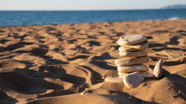 Close-Up Of Rocks Stacked In Pyramid On Sand On Kounoula Beach, Corfu, Greece. Small Depth Of Field. High quality photo