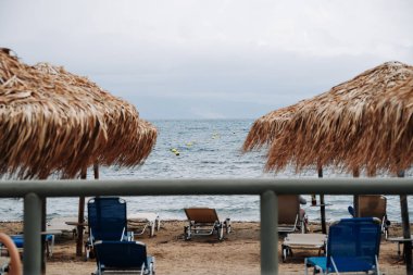 View on Ionian Sea and Greece Balkan Peninsula, Empty Beach and Sunbeds in Hotel, Due To Bad Weather And Rain. High quality photo